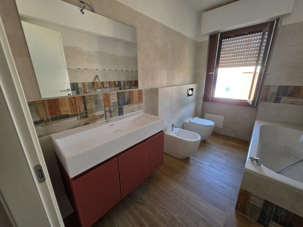 Bagno con mobile rosso e sanitari